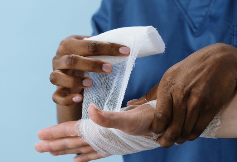 Clinician wrapping an injured hand