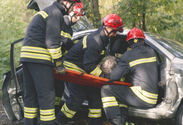 Rescue crew assisting a driver after a collision